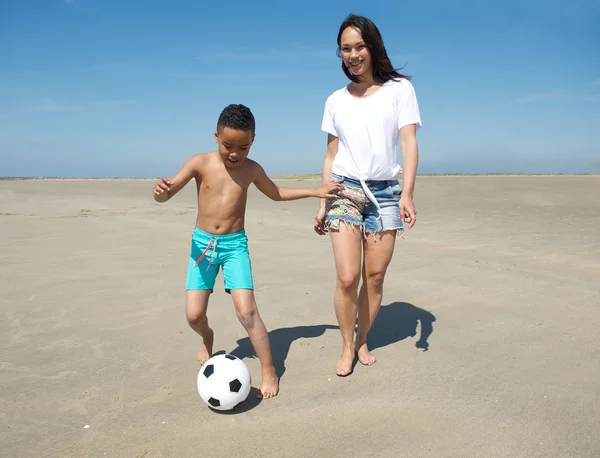 Smiling mother with happy son playing with a ball — Stock Photo, Image