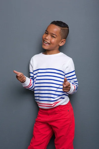 Niño sonriendo y señalando con el dedo —  Fotos de Stock