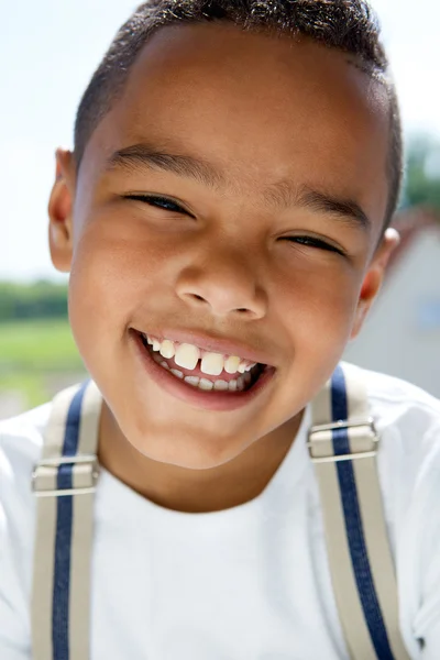 Young boy smiling with suspenders — Stock Photo, Image