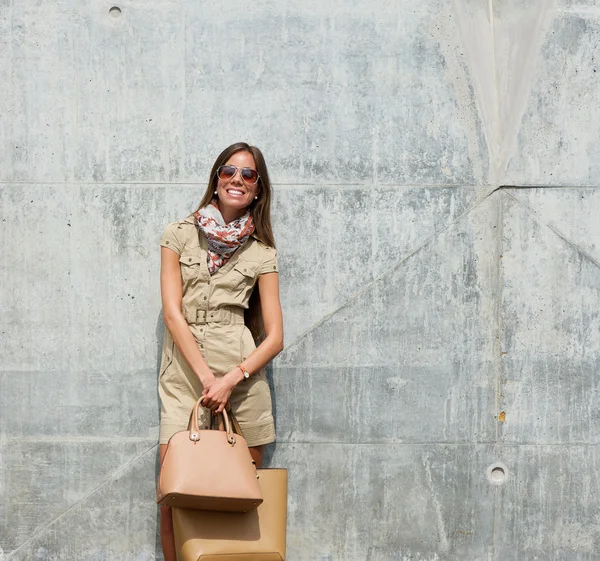 Ung kvinna poserar med väskor utomhus — Stockfoto