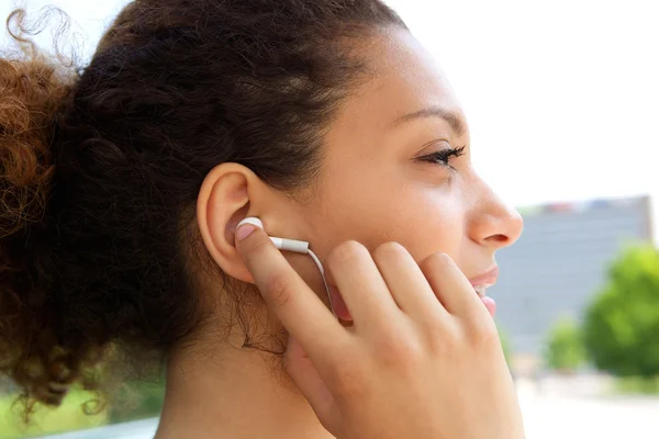 Woman with earphones in ears — Stock Photo, Image