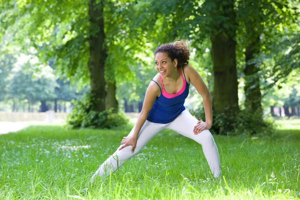 Young woman stretching outdoors — Stock Photo, Image