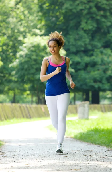 Healthy young woman running outdoors — Stock Photo, Image