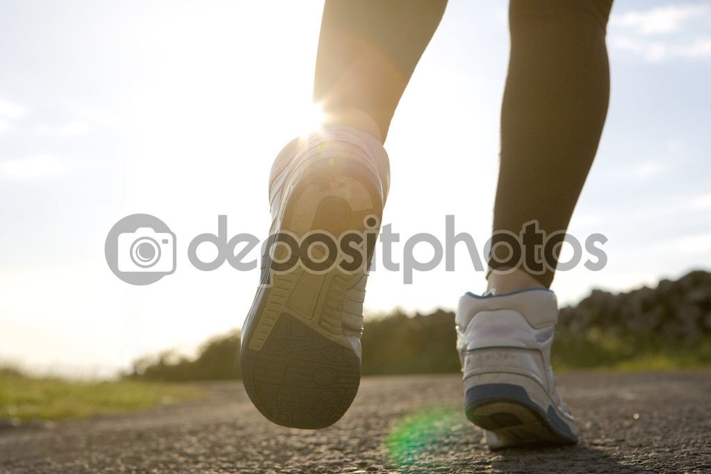 Low angle of woman jogging on street