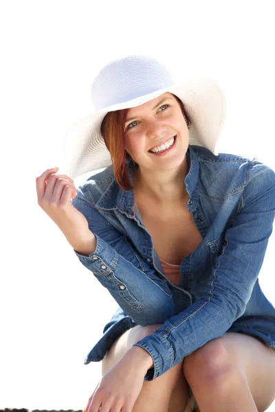 Cheerful young woman sitting outdoors Stock Image