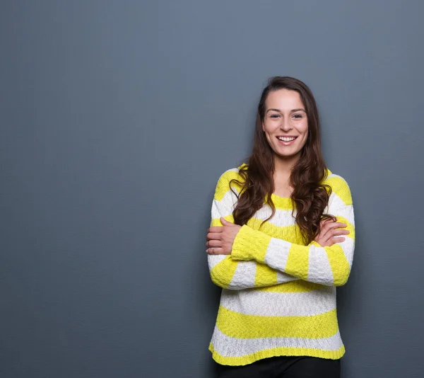 Brunette woman smiling with arms crossed — Stock Photo, Image