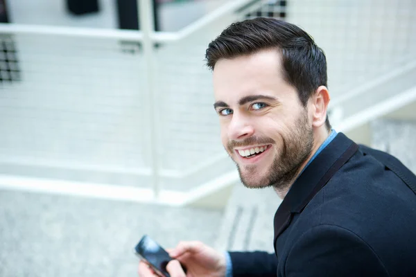 Cool guy smiling with mobile phone