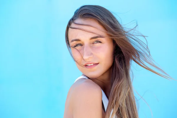 Beautiful young woman with hair blowing — Stock Photo, Image