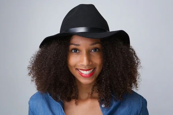 Молода чорна жінка посміхається з капелюхом — стокове фото