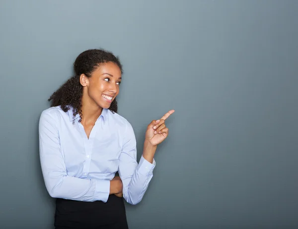 Happy business woman pointing finger — Stock Photo, Image