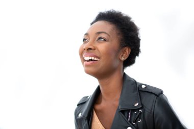 Close up candid portrait happy young african American woman with leather jacket against isolated white background 
