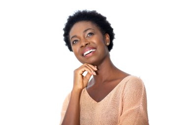 Close up portrait attractive young african American woman smiling with hands on chin by white background