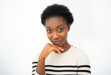 Close up portrait thinking young African American woman with hand on chin by isolated white background 
