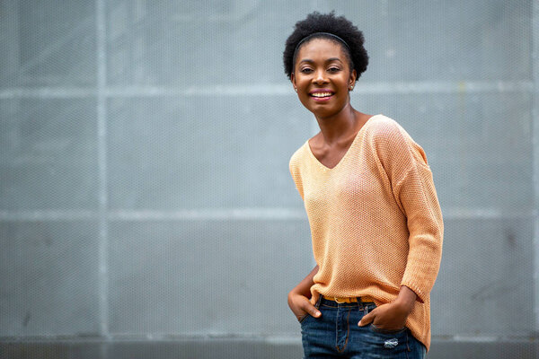 Horizontal portrait smiling young black woman against gray background