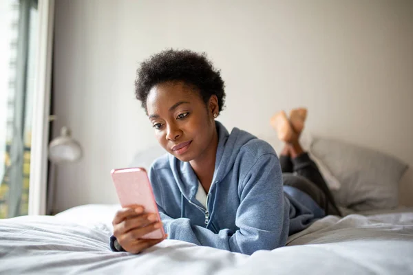 Portrait Young African American Woman Lying Bed Looking Cellphone — Stockfoto