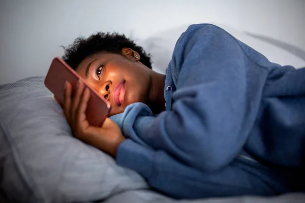 Close Portrait Young African American Woman Bed Looking Cellphone — 图库照片