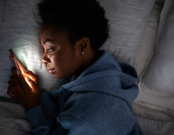 Top Portrait Young African American Woman Looking Cellphone Bed — Stockfoto