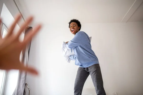 Portrait Carefree Young Black Woman Bedroom Pillow Fight —  Fotos de Stock