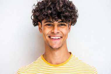 Close up portrait smiling young North African man against white abxckground