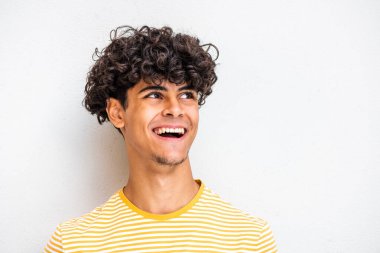 Close up face portrait young North African man laughing and looking away