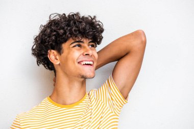 Close up portrait happy young North African man with hand behind head and looking away