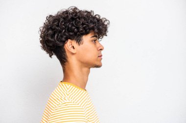 Profile portrait young North African man against white background