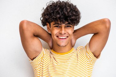 Close up portrait smiling young man with hands behind head 