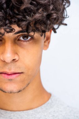 Close up half face portrait young man with curly hair