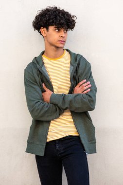 Portrait young handsome man with arms crossed and looking away