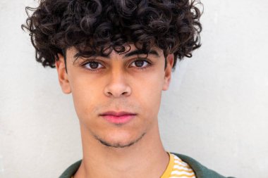 Close up portrait serious young North African man staring