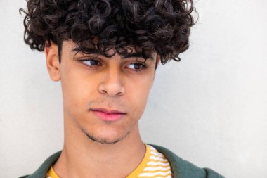 Close up portrait young man white background glance away