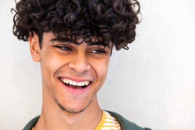 Close up portrait happy young man laughing glancing away