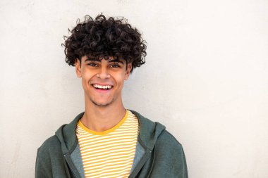 Close up portrait happy young man smiling by white background 