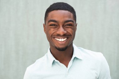 Close up front portrait smiling African American young man 