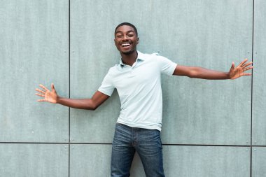 Portrait cheerful young African American laughing with arms spread open