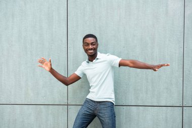 Portrait young African American man smiling with arms open 