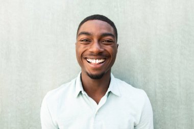 Close up front portrait laughing young African American man
