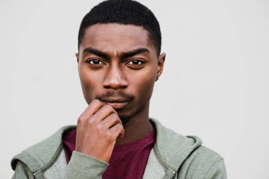 Close up portrait young black man with thinking expression on face