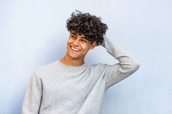 Portrait Young Man Laughing Hand Hair Blue Wall — Stockfoto