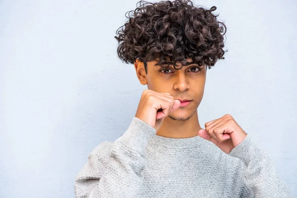 Close up portrait young North African man with fists up
