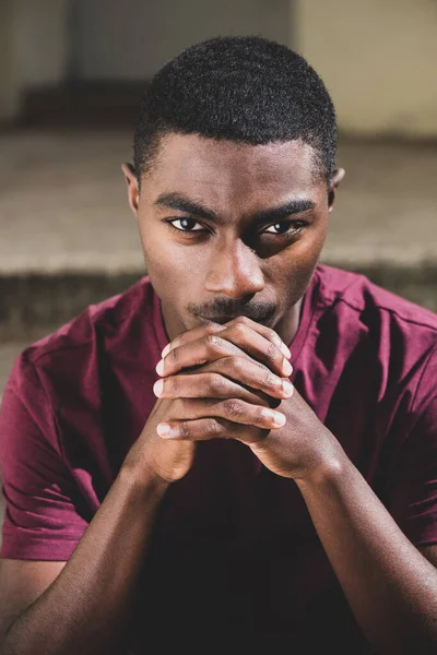 Close Portrait Young African American Man Staring Chin Clasp Hands — Stockfoto