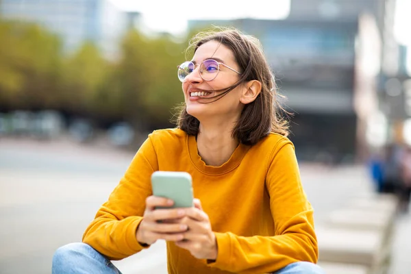 Portrait Relaxed Young Woman Sitting City Her Smart Phone Looking — стоковое фото