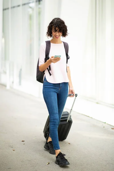 Boldog Női Utazó Üzenetküldés Mobiltelefonnal Miközben Húzza Gördülő Bőrönd Városban — Stock Fotó
