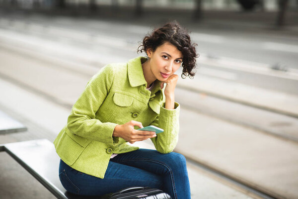 Portrait Stylish Young Woman Using Mobile Phone While Waiting Bus Royalty Free Stock Images
