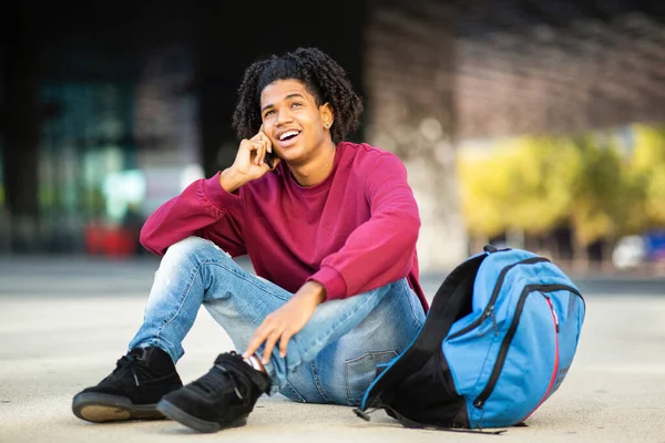 Happy African American Man Talking Smart Phone While Sitting Outdoor — Stok Foto