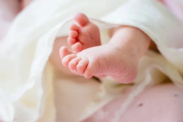 Yeni doğmuş şirin bir bebeğin çıplak ayakları. Çocukluk. Uyuyan yeni doğan bebek. Cildine dikkat et. Seçici odaklanma.
