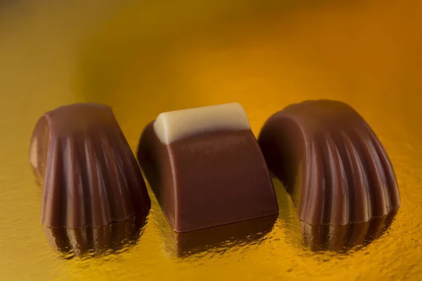 Chocolates on a yellow background — Stock Photo, Image