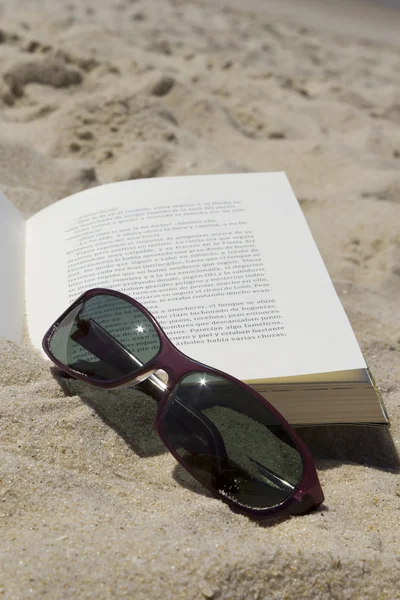 Close up of the sunglasses on a book — Stock Photo, Image