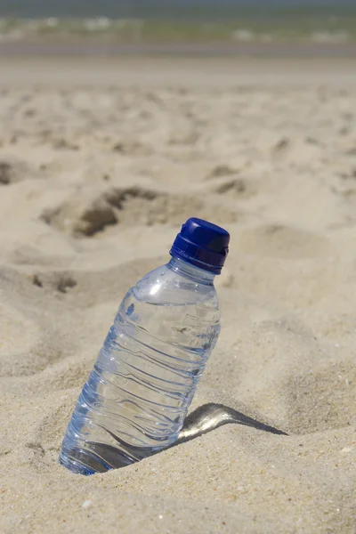 Botella de agua en la playa — Foto de Stock