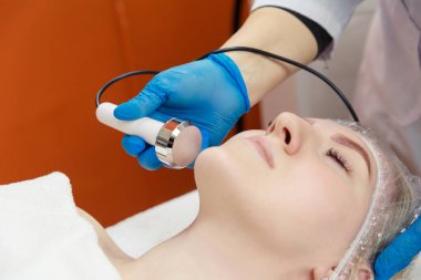 Yüzünün oyulma prosedüründe genç bir kadının büyük bir portresi. Donanım kuyrukluyıldızının yüz şekli düzeltiliyor.